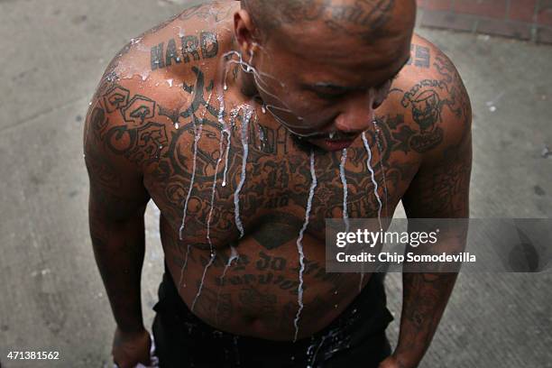 Mixture of milk and water rolls down a man's chest after he was pepper sprayed by the Baltimore Police during violent protests following the funeral...