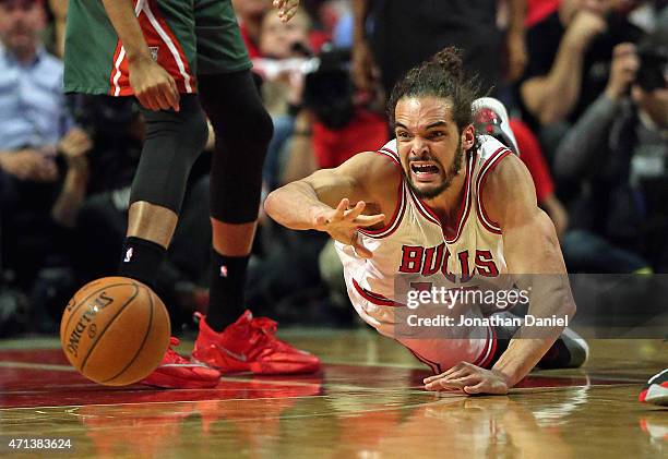 Joakim Noah of the Chicago Bulls gets off a pass as he hit the floor against the Milwaukee Bucks during the first round of the 2015 NBA Playoffs at...