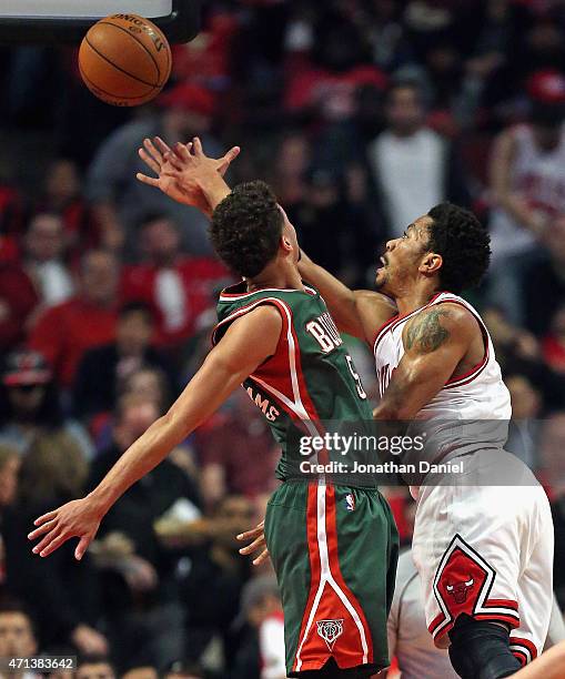 Derrick Rose of the Chicago Bulls shoots around Michael Carter-Williams of the Milwaukee Bucks during the first round of the 2015 NBA Playoffs at the...