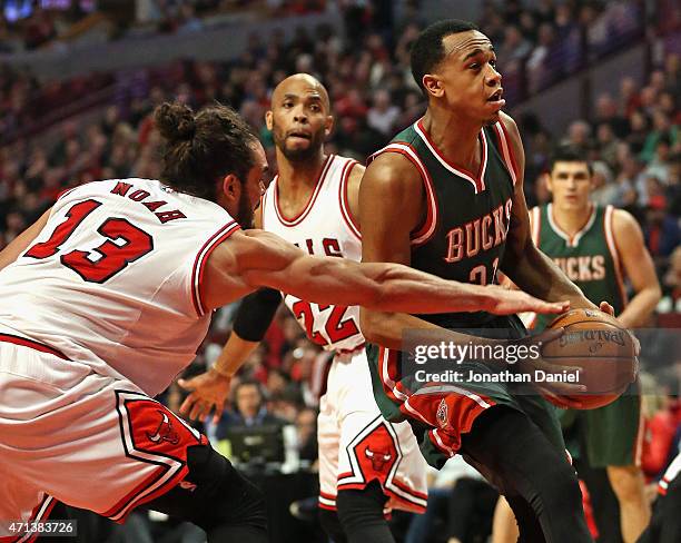 Joakim Noah of the Chicago Bulls knocks the ball away from Khris Middleton of the Milwaukee Bucks during the first round of the 2015 NBA Playoffs at...