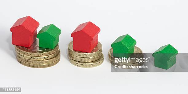 more money equals bigger house - two pound coin stock pictures, royalty-free photos & images