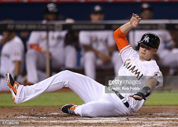 Reid Brignac of the Miami Marlins scores a run during the eighth inning of the game against the New York Mets at Marlins Park on April 27, 2015 in...