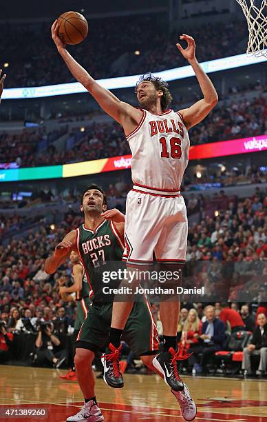 Pau Gasol of the Chicago Bulls grabs a rebound over Zaza Pachulia of the Milwaukee Bucks during the first round of the 2015 NBA Playoffs at the...