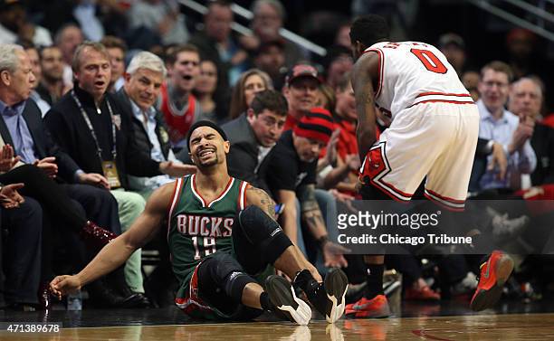 Milwaukee Bucks guard Jerryd Bayless falls out of bounds while Chicago Bulls guard Aaron Brooks defends during the first half on Monday, April 27 at...