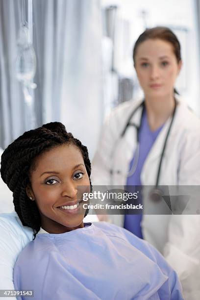 beautiful african female patient having a medical exam. - bedside manner stock pictures, royalty-free photos & images