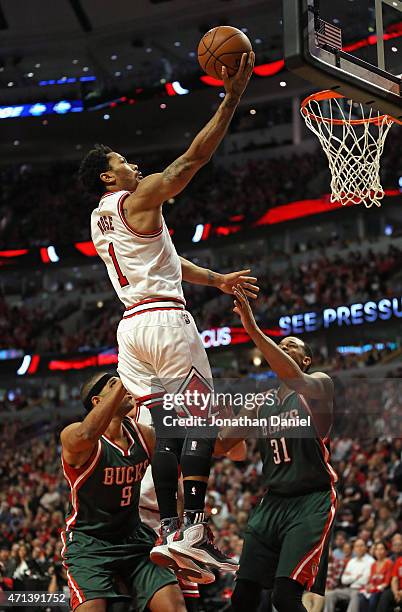 Derrick Rose of the Chicago Bulls goes up for a shot over Jared Dudley and John Henson of the Milwaukee Bucks during the first round of the 2015 NBA...