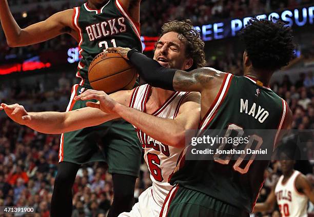 Pau Gasol of the Chicago Bulls is fouleds by O.J. Mayo of the Milwaukee Bucks during the first round of the 2015 NBA Playoffs at the United Center on...