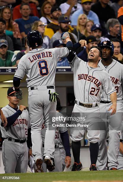 Jed Lowrie of the Houston Astros is congratulated by Jose Altuve after hitting a solo home run during the fourth inning of a baseball game against...