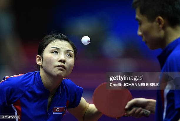 Kim Hyok Bong and Kim Jong of South Korea serve during their mixed doubles match against Diogo Chen and Leila Oliveira of Portugal in the 2015 World...
