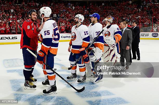 Alex Ovechkin of the Washington Capitals and Johnny Boychuk of the New York Islanders shake hands following the Capitals victory over the Islanders...