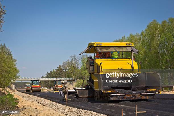 road construction machines at work - asphalt paver stock pictures, royalty-free photos & images