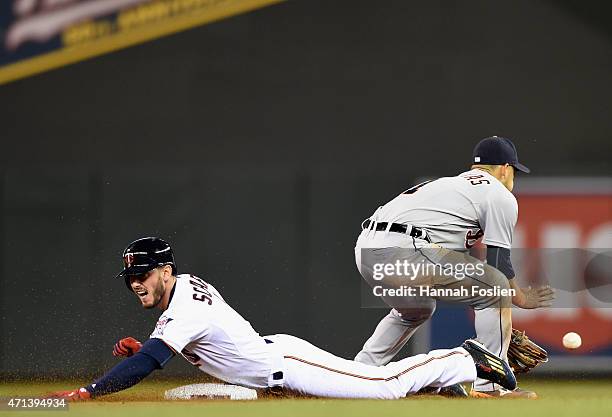 Jordan Schafer of the Minnesota Twins slides safely into second base as Jose Iglesias of the Detroit Tigers fields the ball during the seventh inning...