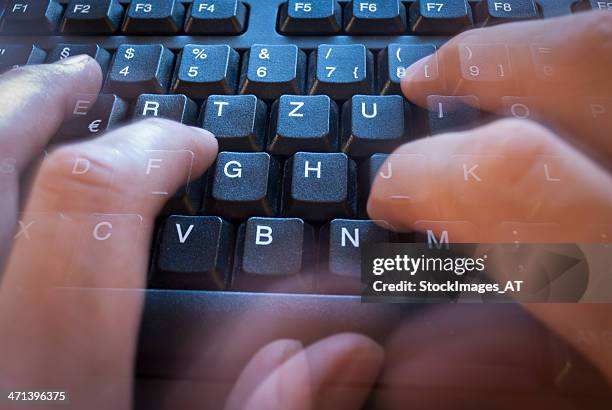 very fast writing on a modern black keyboard - cyberbullying stockfoto's en -beelden