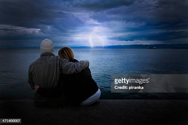 couple looking at storm - watching thunderstorm stock pictures, royalty-free photos & images