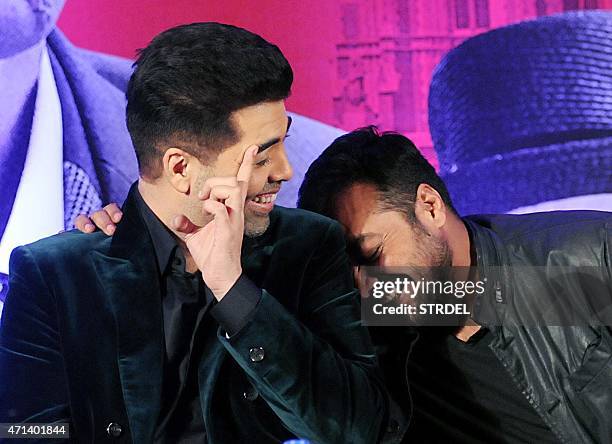 Indian Bollywood actor Karan Johar and writer, director and producer Anurag Kashyap share a light moment during a promotional event for the...