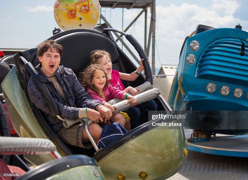 Father with daughters in the amusement park