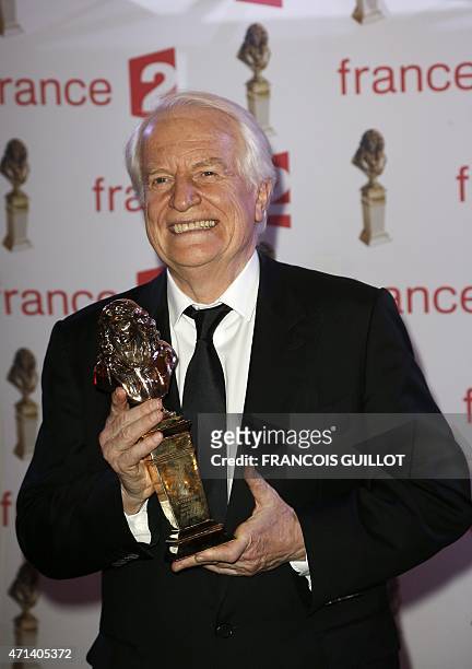 French actor Andre Dussolier poses after being awarded best actor in a public theatre for his role in "Novencento" during the 27th Molieres French...