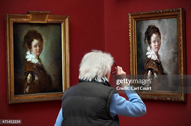 Visitor views a replica of Jean-Honore Fragonard's 18th Century painting 'Young Woman' as the original hangs to its left on April 28, 2015 at Dulwich...
