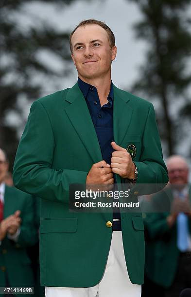 Jordan Spieth of the United States is presented with his Green Jacket after the final round of the 2015 Masters at Augusta National Golf Club on...