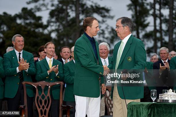 Jordan Spieth of the United States is congratulated by Billy Payne the Chairman of Augusta National Golf Club after the final round of the 2015...