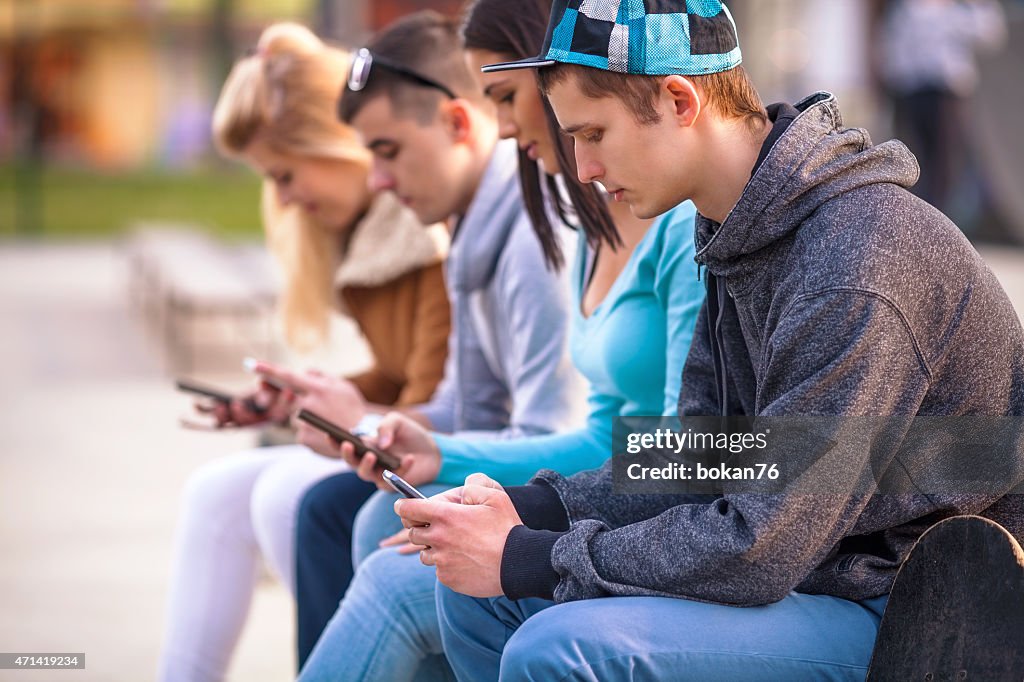 Teenagers Using Mobile Phones