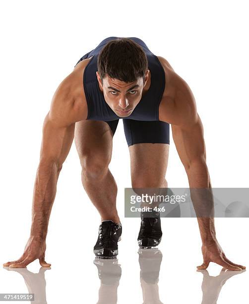 male runner at starting line before race - runner sprinting stock pictures, royalty-free photos & images