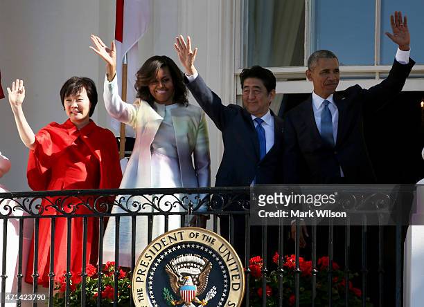 President Barack Obama and first lady Michelle Obama stand with Japanese Prime Minister Shinzo Abe and his wife Akie Abe during an official arrival...