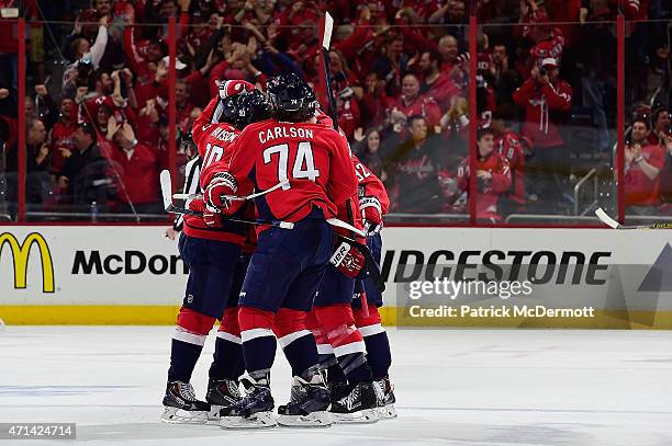 Evgeny Kuznetsov of the Washington Capitals celebrates with his teammates afer scoring the game winning goal in the third period against the New York...