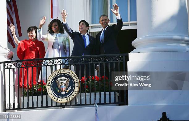 President Barack Obama , first lady Michelle Obama , Japanese Prime Minister Shinzo Abe and his wife Akie Abe wave from the Truman Balcony during an...