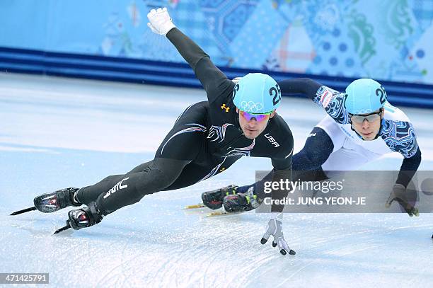 Eduardo Alvarez and Russia's Semen Elistratov in the Men's Short Track 5000 m Relay Final at the Iceberg Skating Palace during the Sochi Winter...