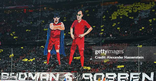 E fans of Bayern Muenchen make character figures of Franck Ribery and Arjen Robben as batman and robin prior to the start of the DFB Cup semi final...