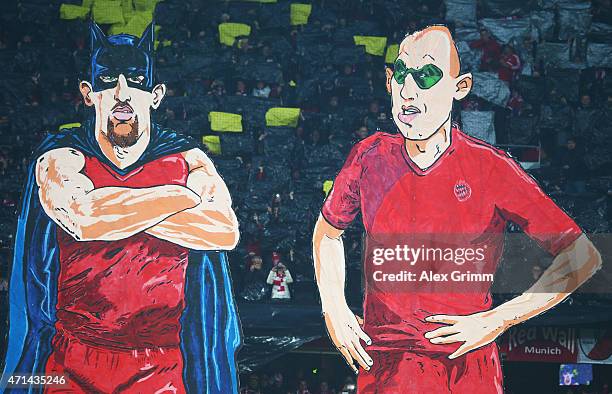 E fans of Bayern Muenchen make character figures of Franck Ribery and Arjen Robben as batman and robin prior to the start of the DFB Cup semi final...