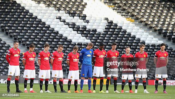 The Manchester United team take part in a minute's silence for a member of Fulham staff ahead of the Barclays U21 Premier League match between Fulham...