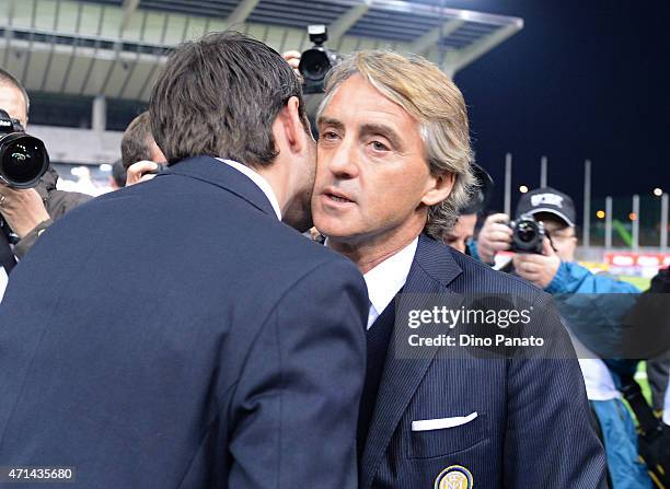 Head coach of FC Internazionale Milano Roberto Mancini and Head coach of Udinese Andrea Stramaccioni greet one another during the Serie A match...