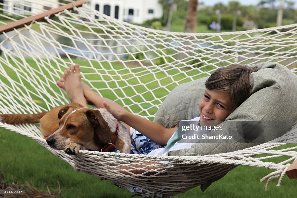 Boy and his Dog relaxing in Hammock