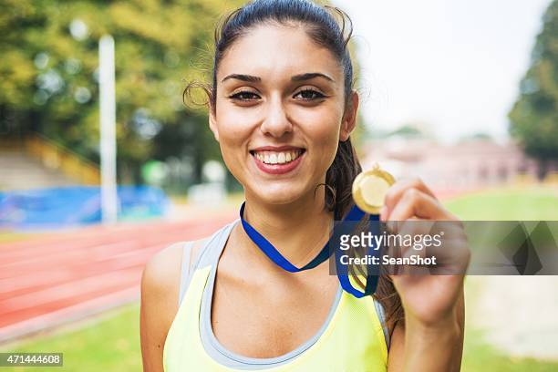 athlete showing medals - sportsperson medal stock pictures, royalty-free photos & images