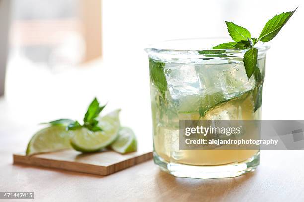 close up of mojito glass with lemon slices blurred in back - refreshment stock pictures, royalty-free photos & images