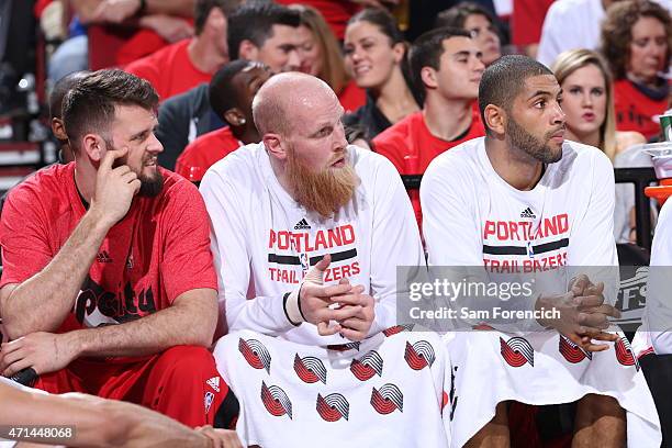 Joel Freeland, Chris Kaman, and Nicolas Batum of the Portland Trail Blazers sit on the sideline during a game against the Memphis Grizzlies in Game...