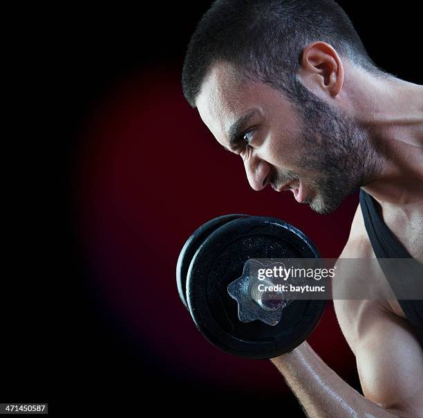 grimacing man lifting weights - grimacing stock pictures, royalty-free photos & images