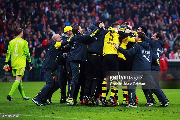 Goalkeeper Manuel Neuer of Muenchen walks by as players of Dortmund celebrate after the DFB Cup Semi Final match between FC Bayern Muenchen and...