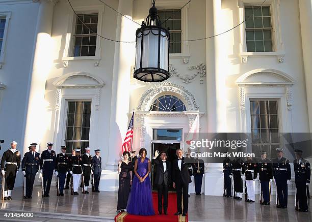 President Barack Obama and first lady Michelle Obama welcome Japanese Prime Minister Shinzo Abe and his wife Akie Abe after they arrived at the north...