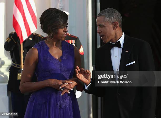 Pesident Barack Obama and first lady Michelle Obama wait for the arrival of Japanese Prime Minister Shinzo Abe and his wife Akie Abe at the north...