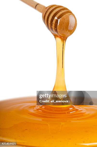 honey dripping from dipper - honey-dipper stock pictures, royalty-free photos & images