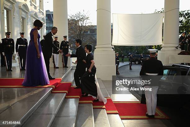 President Barack Obama and first lady Michelle Obama welcome Japanese Prime Minister Shinzo Abe and his wife Akie Abe as they arrive for a state...