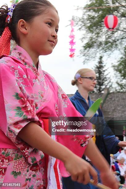 japanese girl dances with another at bon odori folk dance - traditional dancing stock pictures, royalty-free photos & images