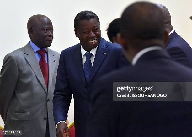 Togo's President Faure Gnassingbe leaves the conference room after a meeting with Ghanian President and ECOWAS chairmen John Dramani Mahama and Ivory...