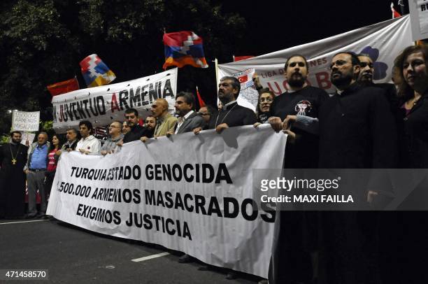 Members of the Armenian community in Argentina take part in a demo for the recognition of the Armenian genocide on April 28, 2015 in Buenos Aires....