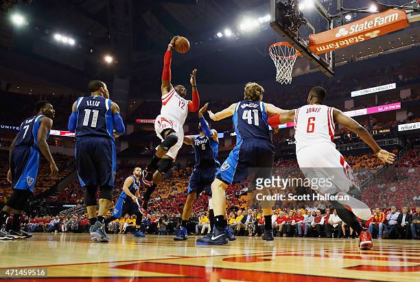Dwight Howard of the Houston Rockets drives to the basket in front of Monta Ellis, Tyson Chandler and Dirk Nowitzki of the Dallas Mavericks during...