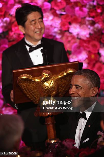 President Barack Obama listens as Japanese Prime Minister Shinzo Abe speaks during a state dinner at the East Room of the White House April 28, 2015...