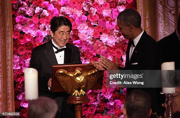 President Barack Obama looks on as Japanese Prime Minister Shinzo Abe takes the podium during a state dinner at the East Room of the White House...